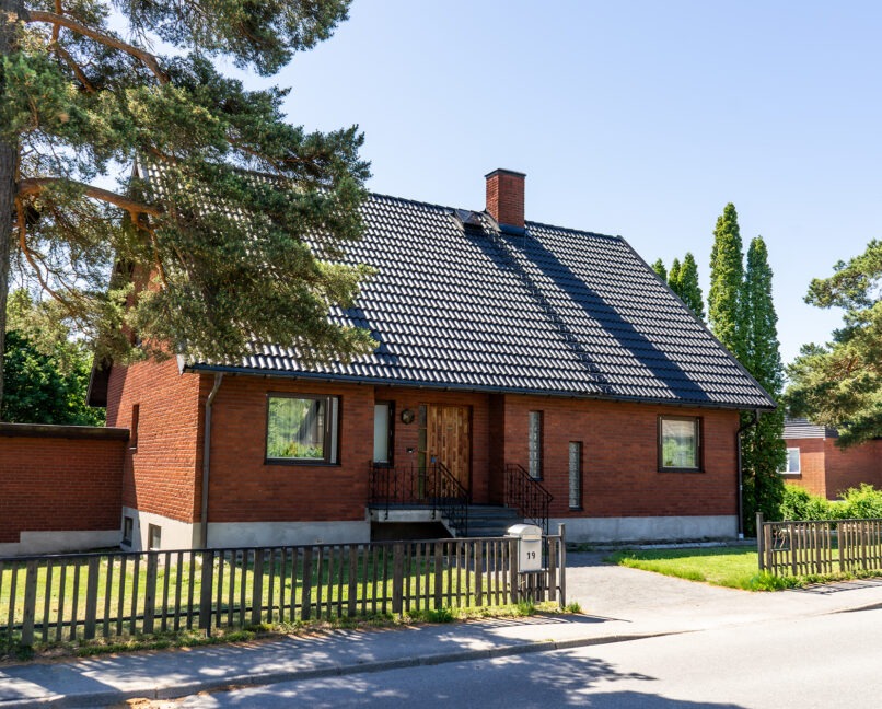 Svart betongtak på tegelhus.